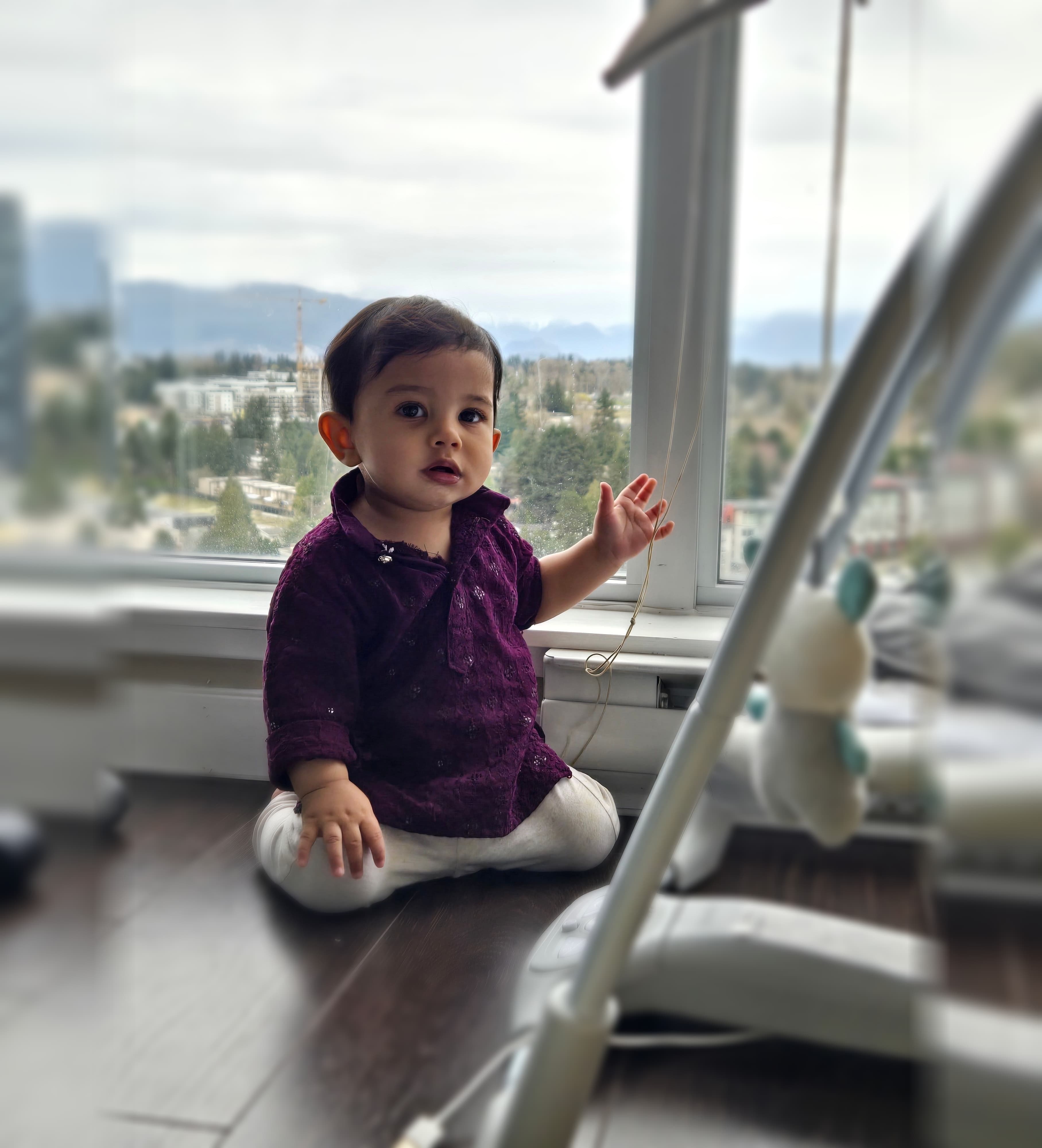 Salahaddin as a baby, sitting up and looking towards the camera.